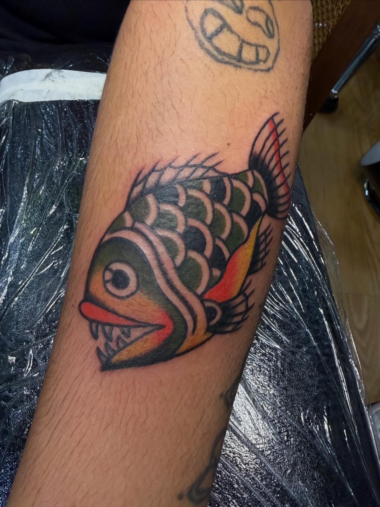 Fish American traditional tattoo on the forearm by 𝕯𝖗𝖆𝕶𝖊㋛