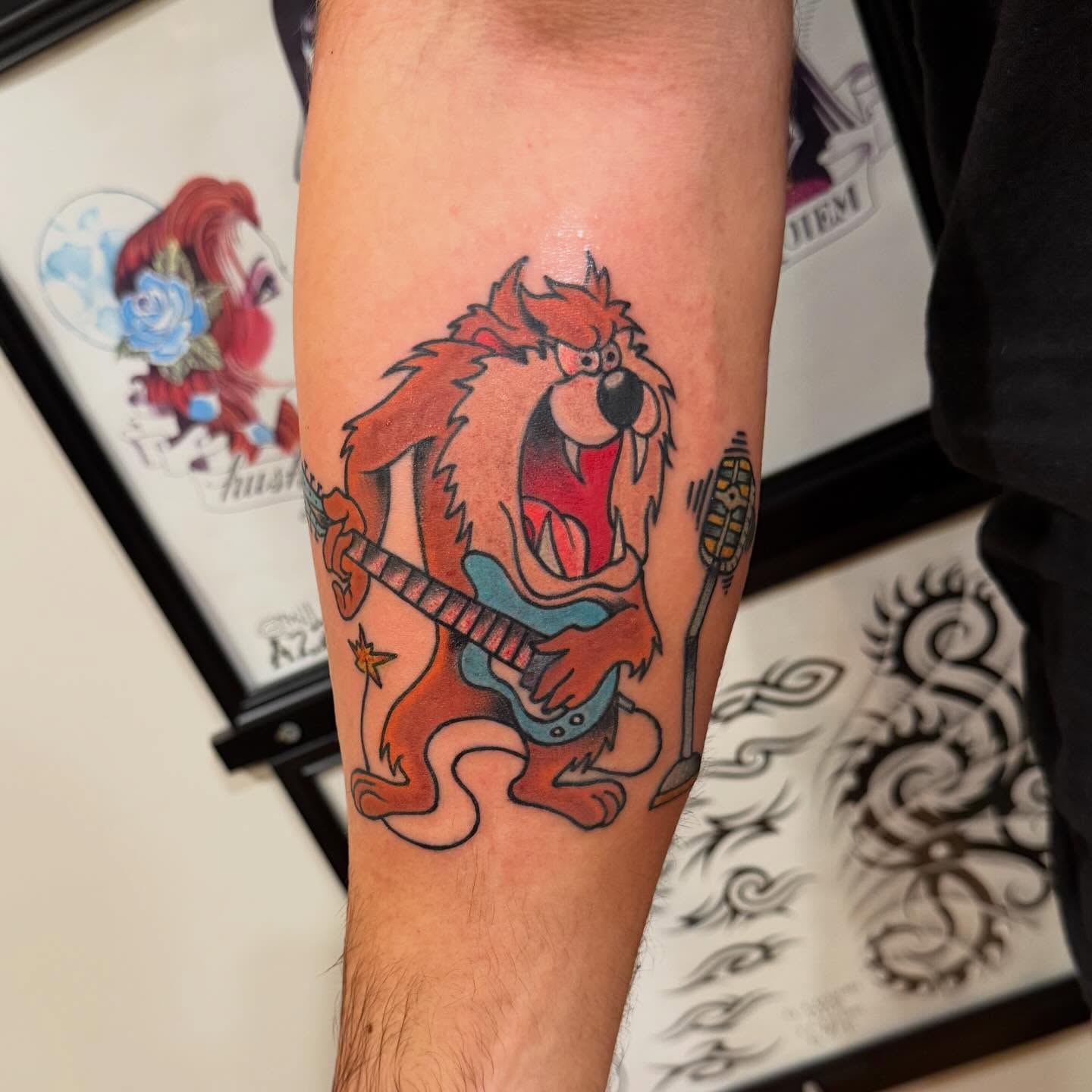 Tazmanian devil playing guitar American traditional tattoo on the forearm by Mike Kepper