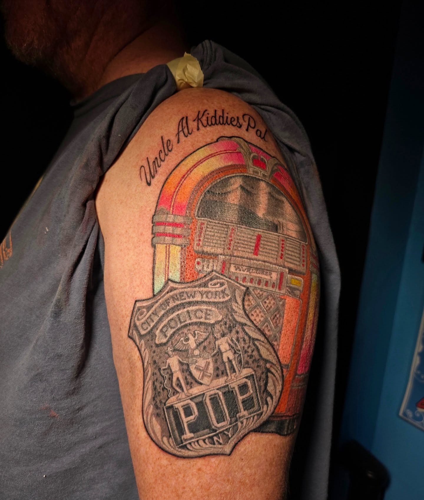 Jukebox police badge realism tattoo on the shoulder by "Gentle"Jay Blondel