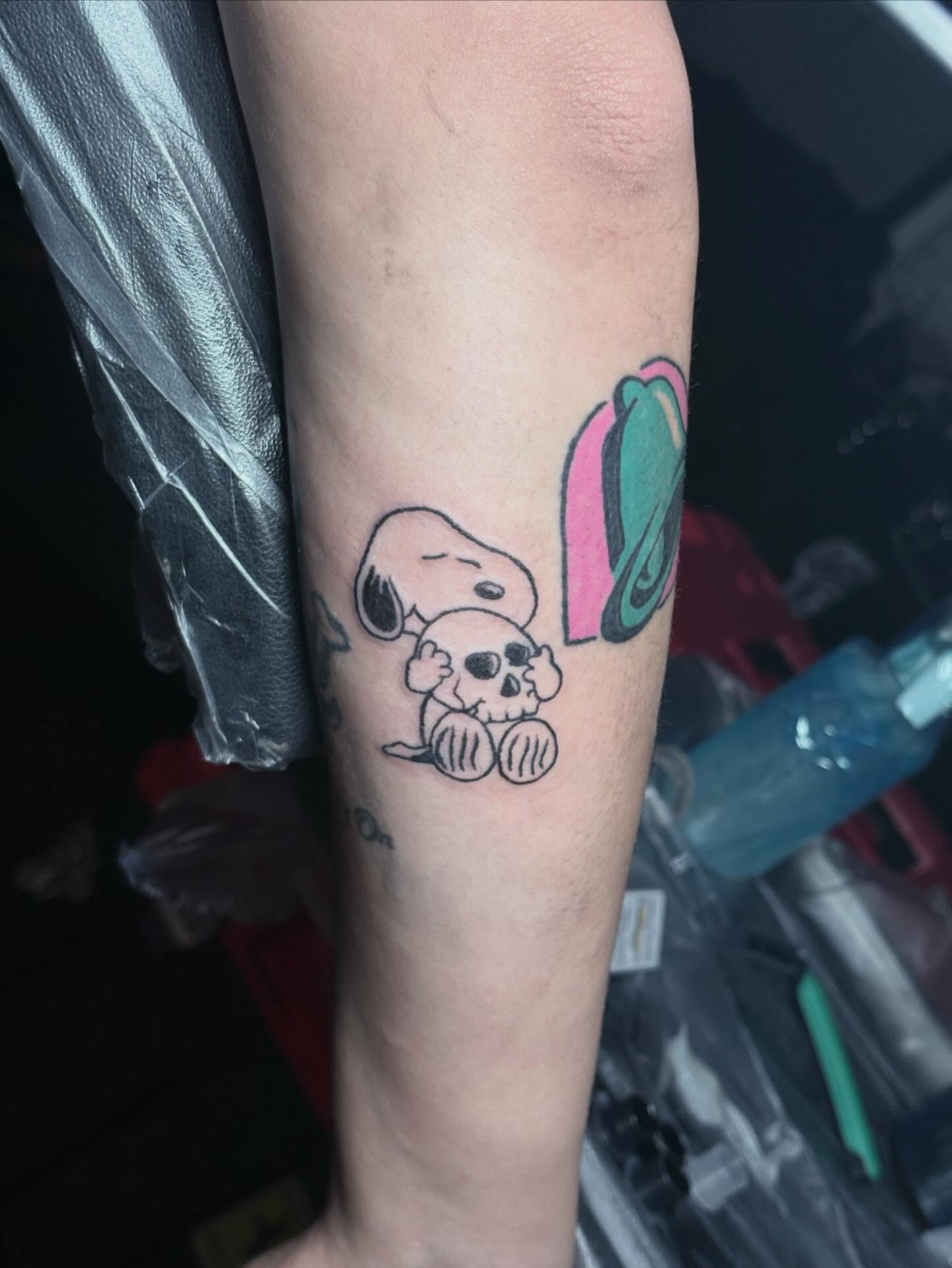 Snoopy with skull American traditional tattoo on the forearm by Angel Arceo