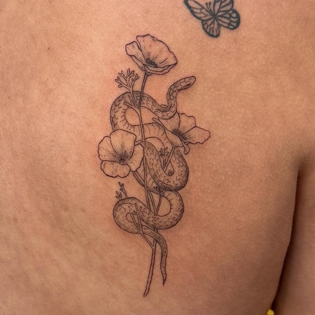 Snake and flowers fine line tattoo on the chest by Kirsten