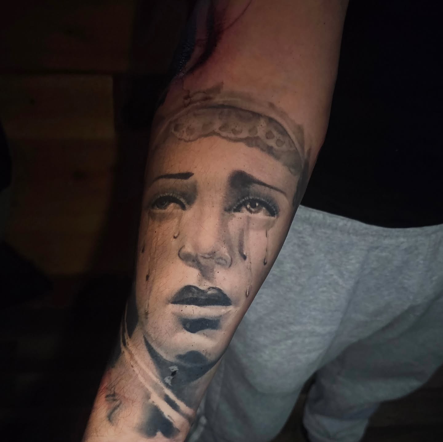 Woman crying realism tattoo on the forearm by Cody Gower Tattoo Artist