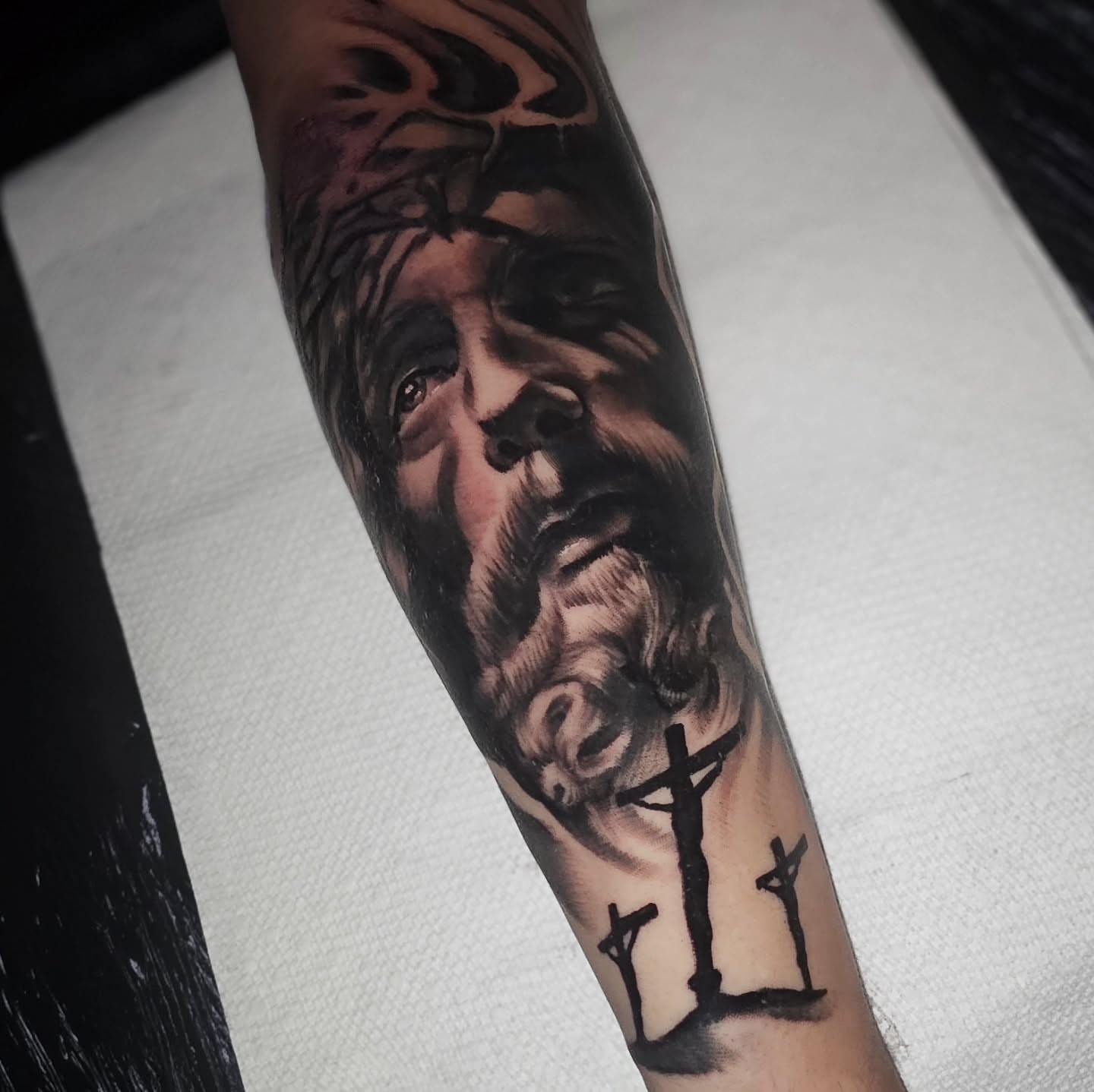 Religious figure realism tattoo on the forearm by Cody Gower Tattoo Artist