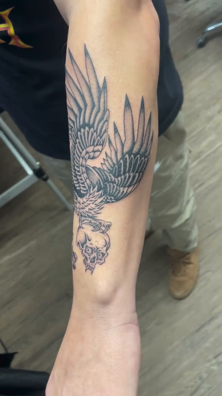 Eagle with skull realism tattoo on the forearm by Brayden P Tattoo