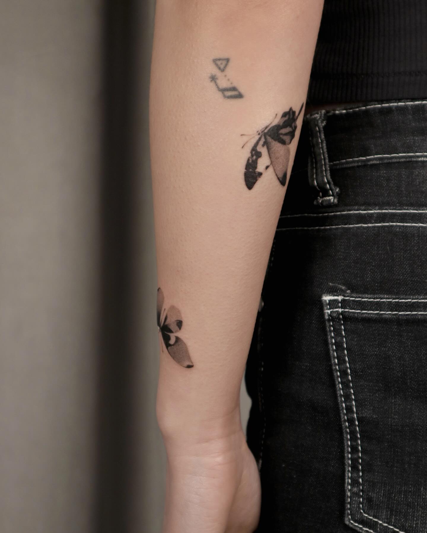 Butterfly black and grey tattoo on the forearm by River, New York, New York