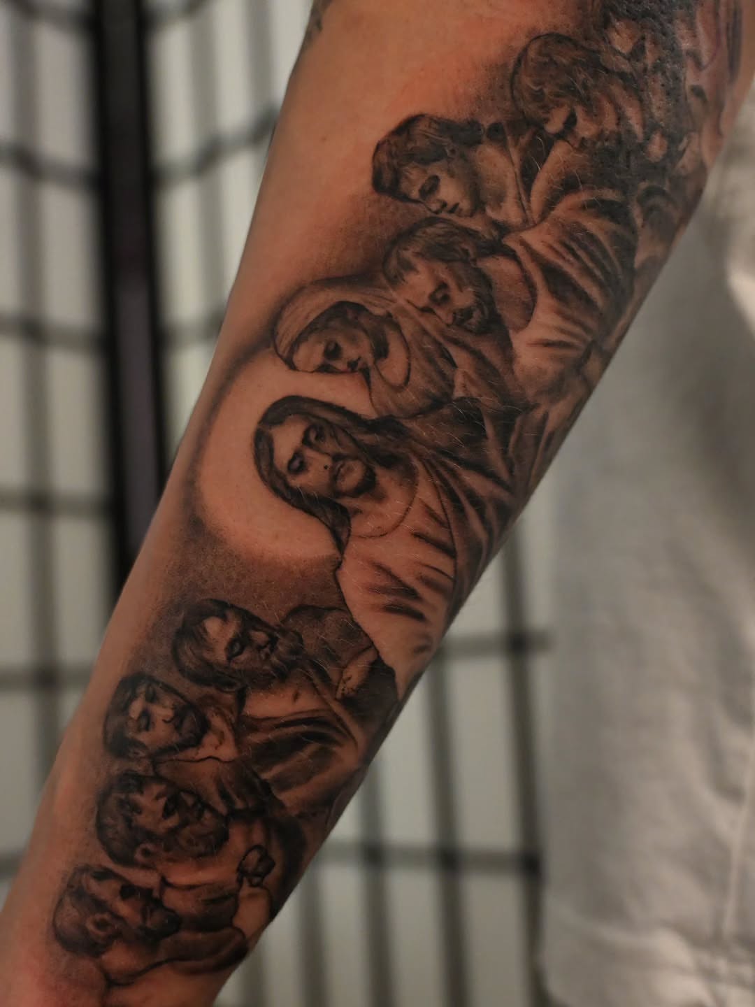 Religious scene realism tattoo on the forearm by Michael ORegan