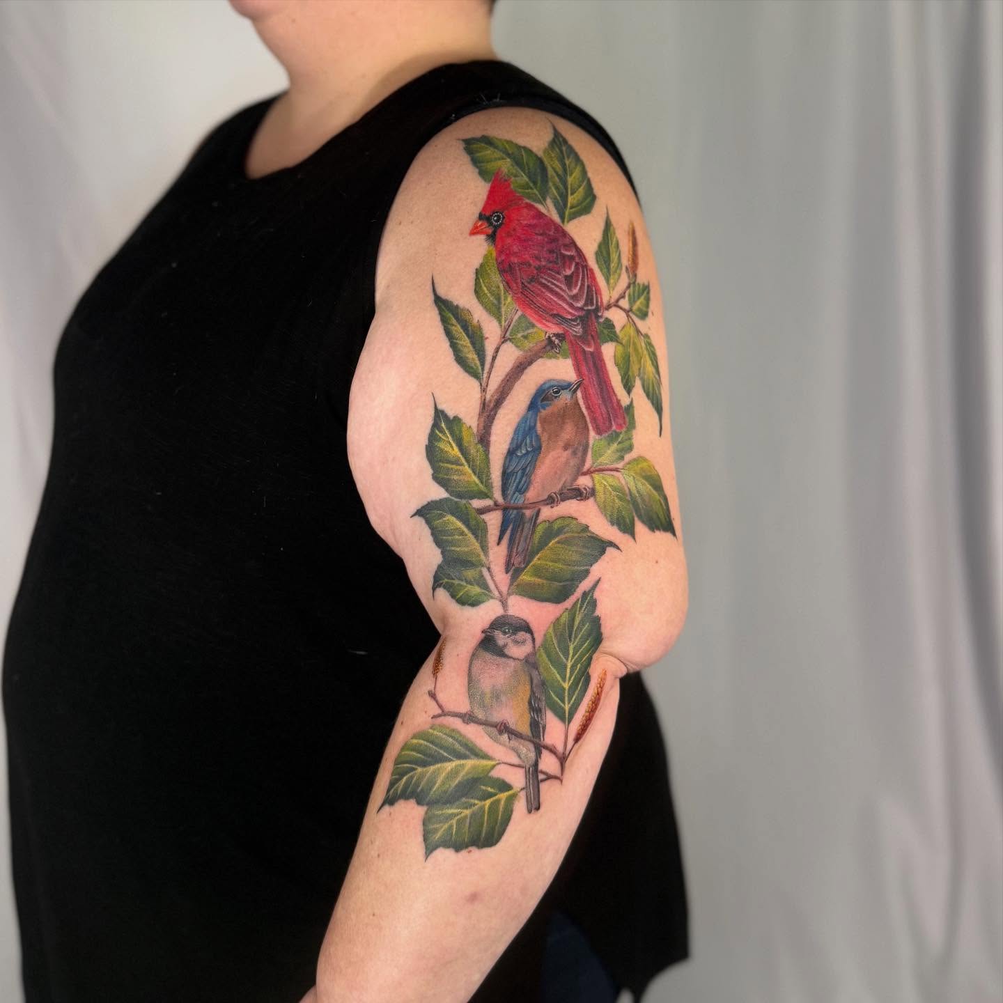 Birds realism tattoo on the upper arm by Sam Minter, Grafton, Massachusetts