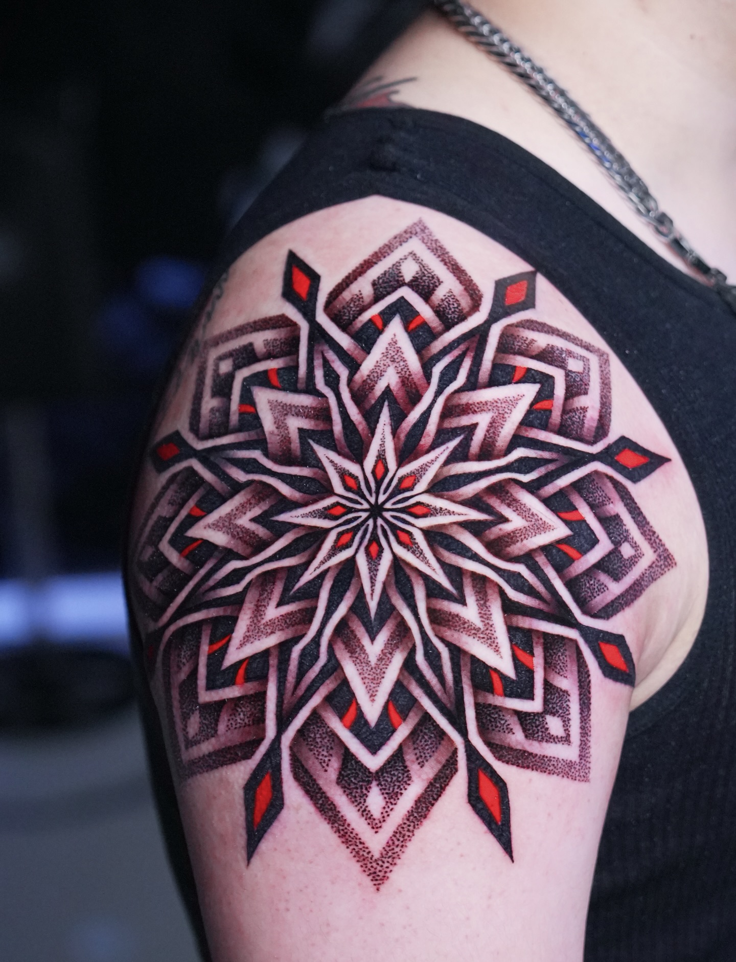 Geometric mandala dotwork tattoo on the shoulder by Ilya Cascad Kandaurov