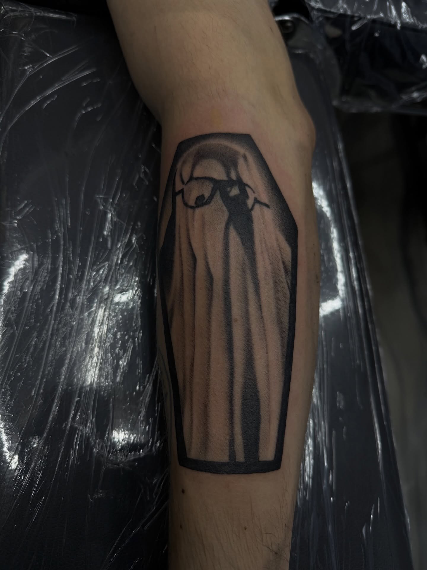 Ghost black and grey tattoo on the forearm by Nick Campbell