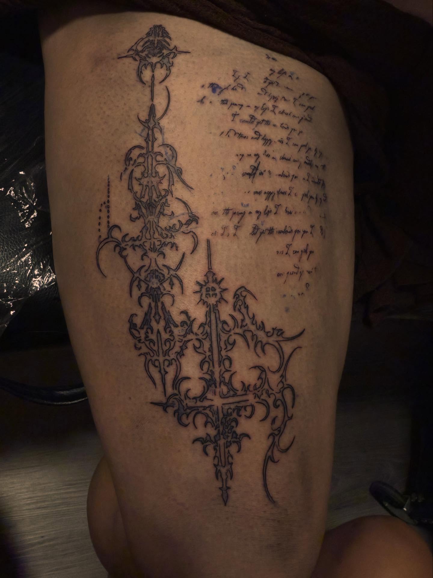 Crosses and script ornamental tattoo on the thigh by Noir