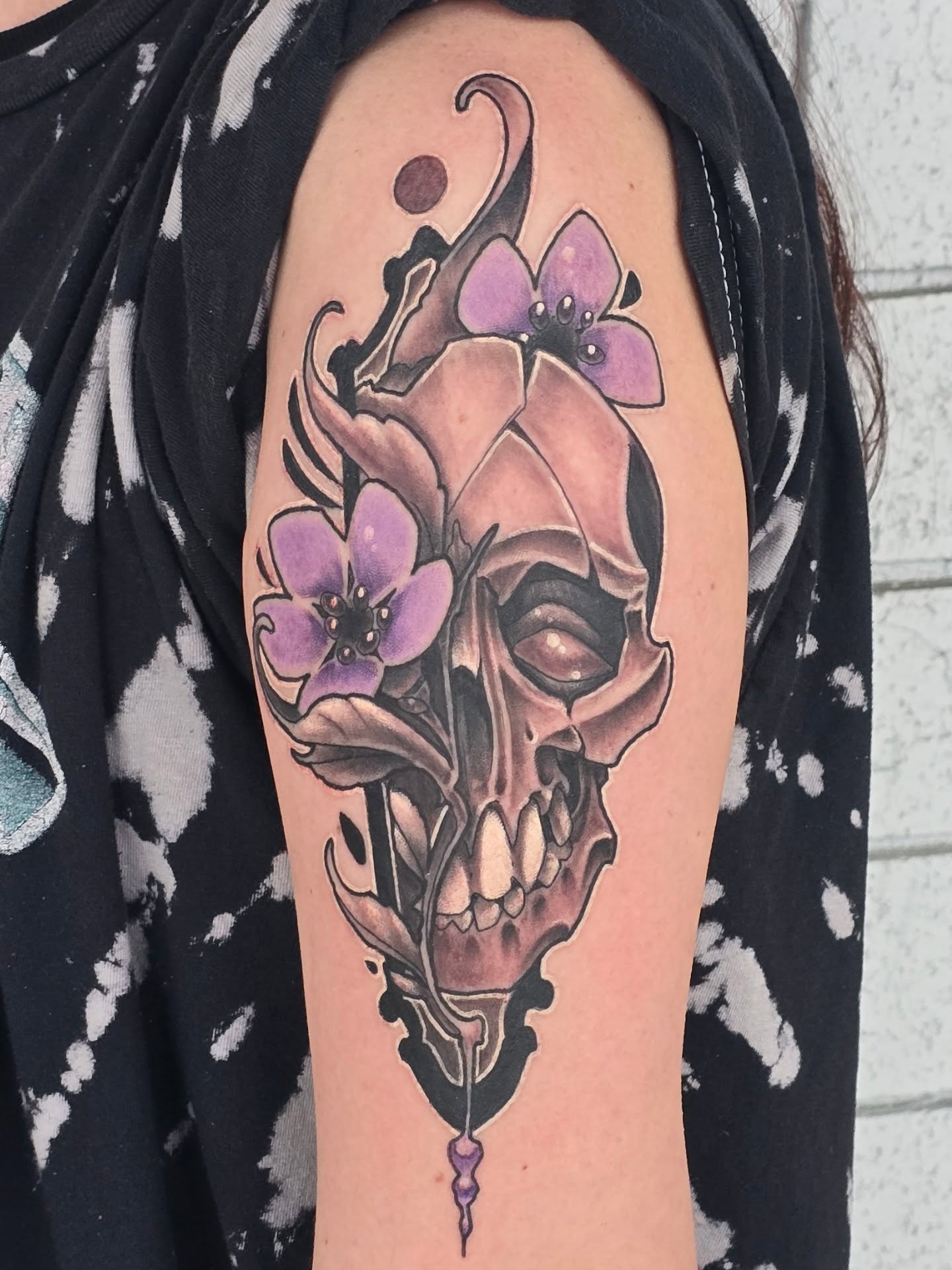 Skull with flowers realism tattoo on the forearm by Steve Atkinson Tattoo Artist