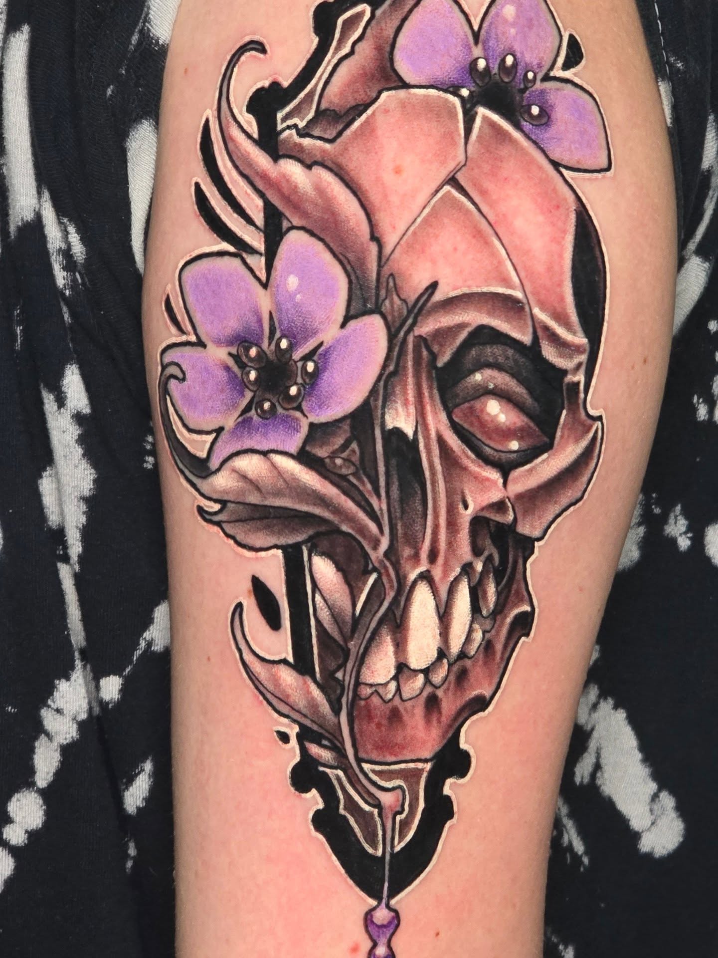 Skull with flowers realism tattoo on the thigh by Steve Atkinson Tattoo Artist