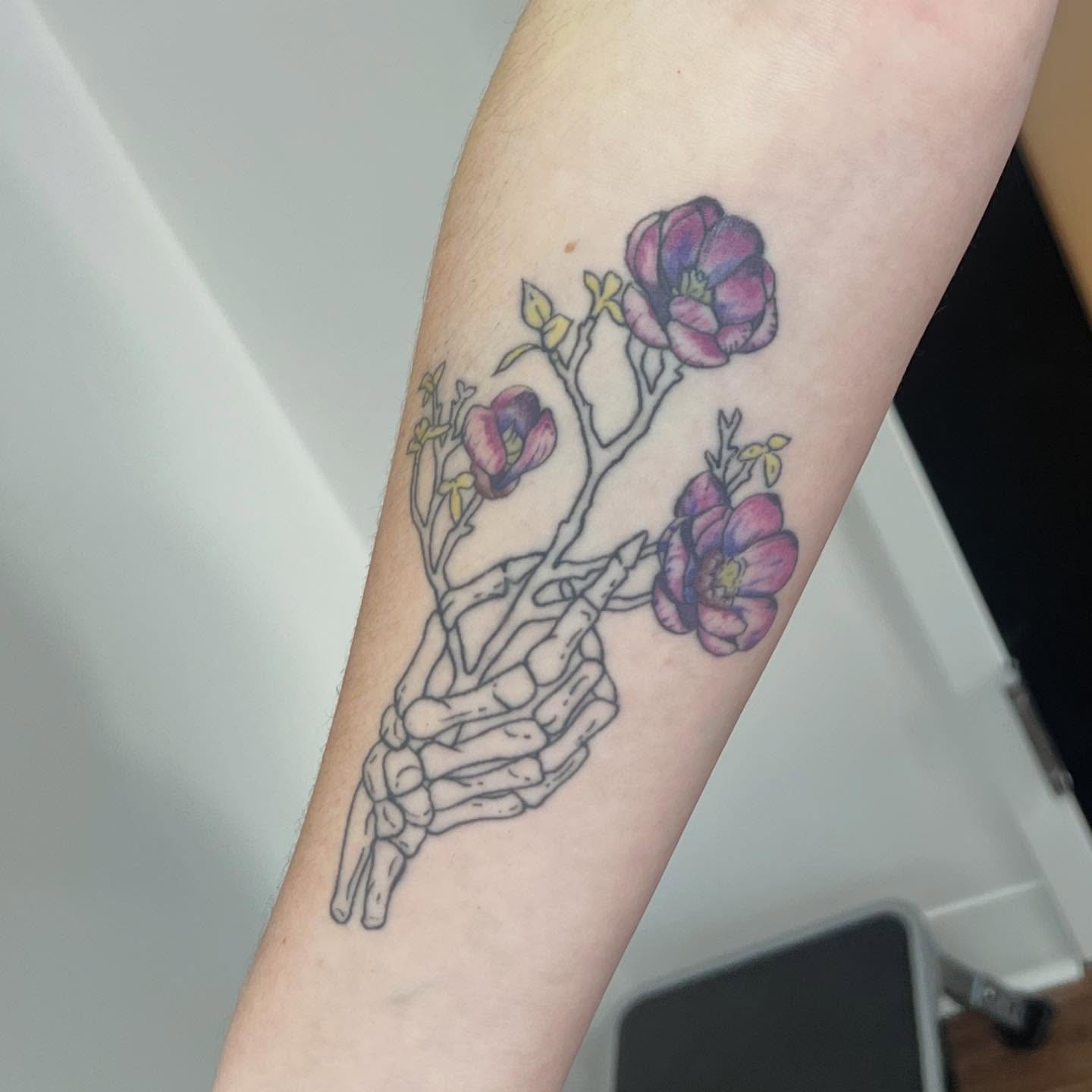 Flower and skeleton hand realism tattoo on the forearm by 🍄‍🟫🍄Moth🍄🍄‍🟫