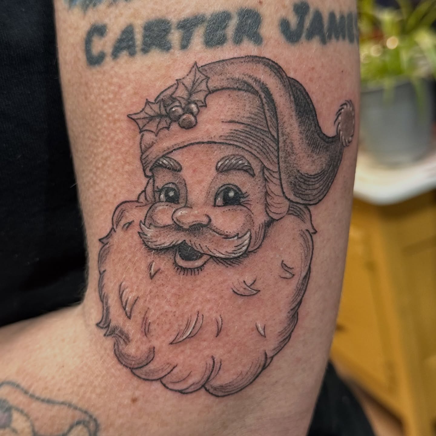 Santa Claus black and grey tattoo on the forearm by Chris Gray