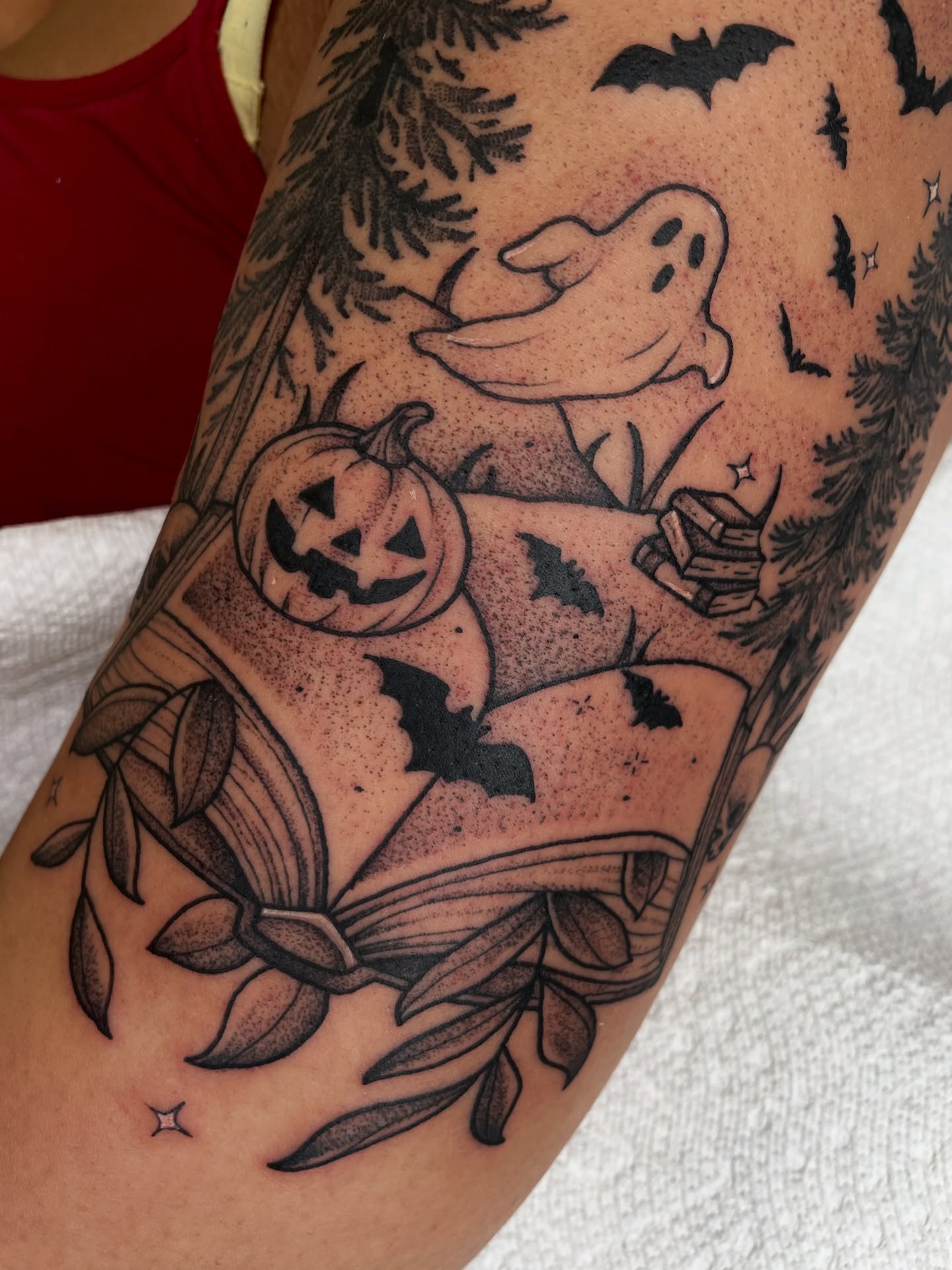 Ghost and pumpkin dotwork tattoo on the forearm by Emily Lux