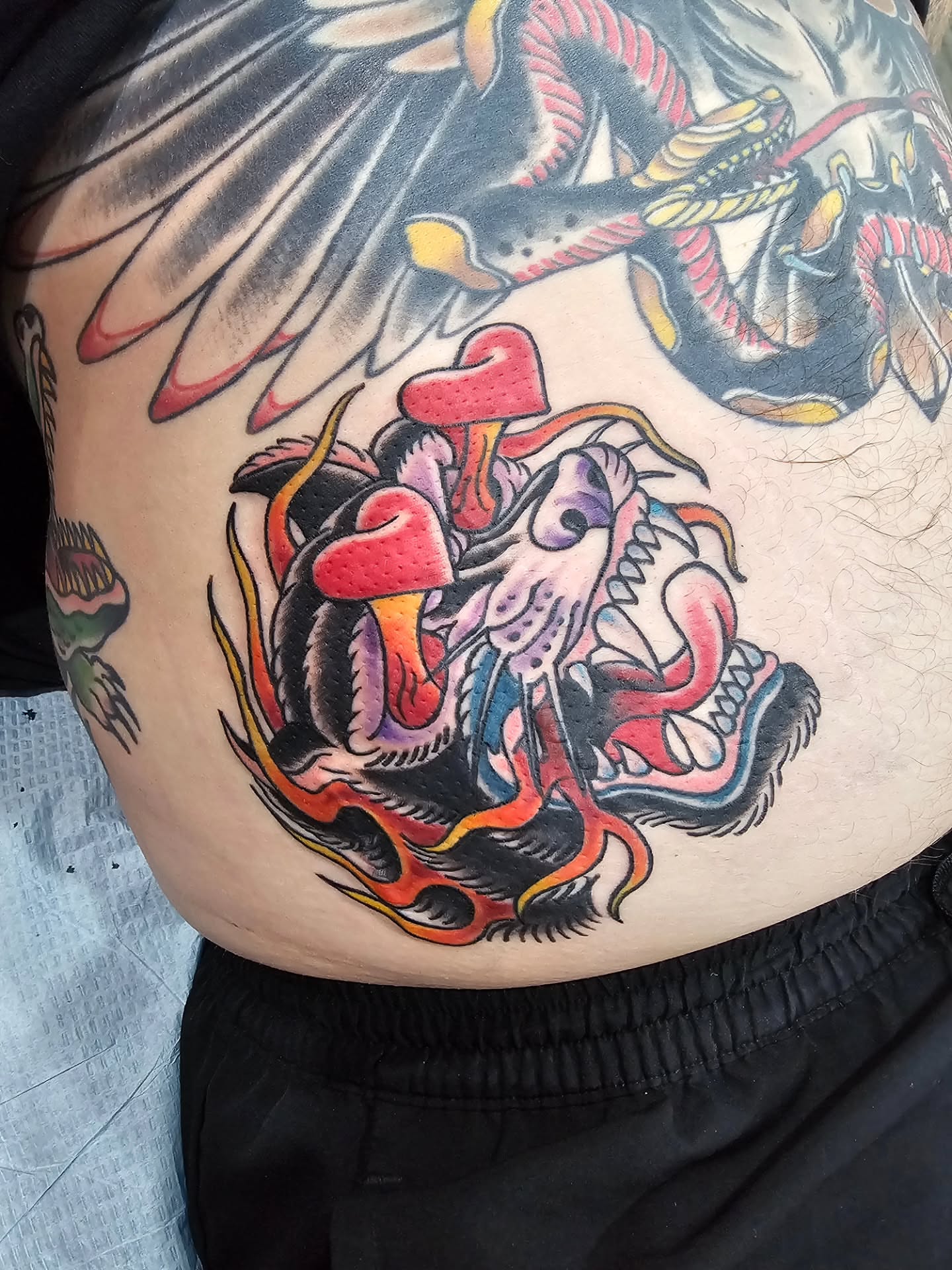 Skull and snake American traditional tattoo on the thigh by Matthew Ashmore
