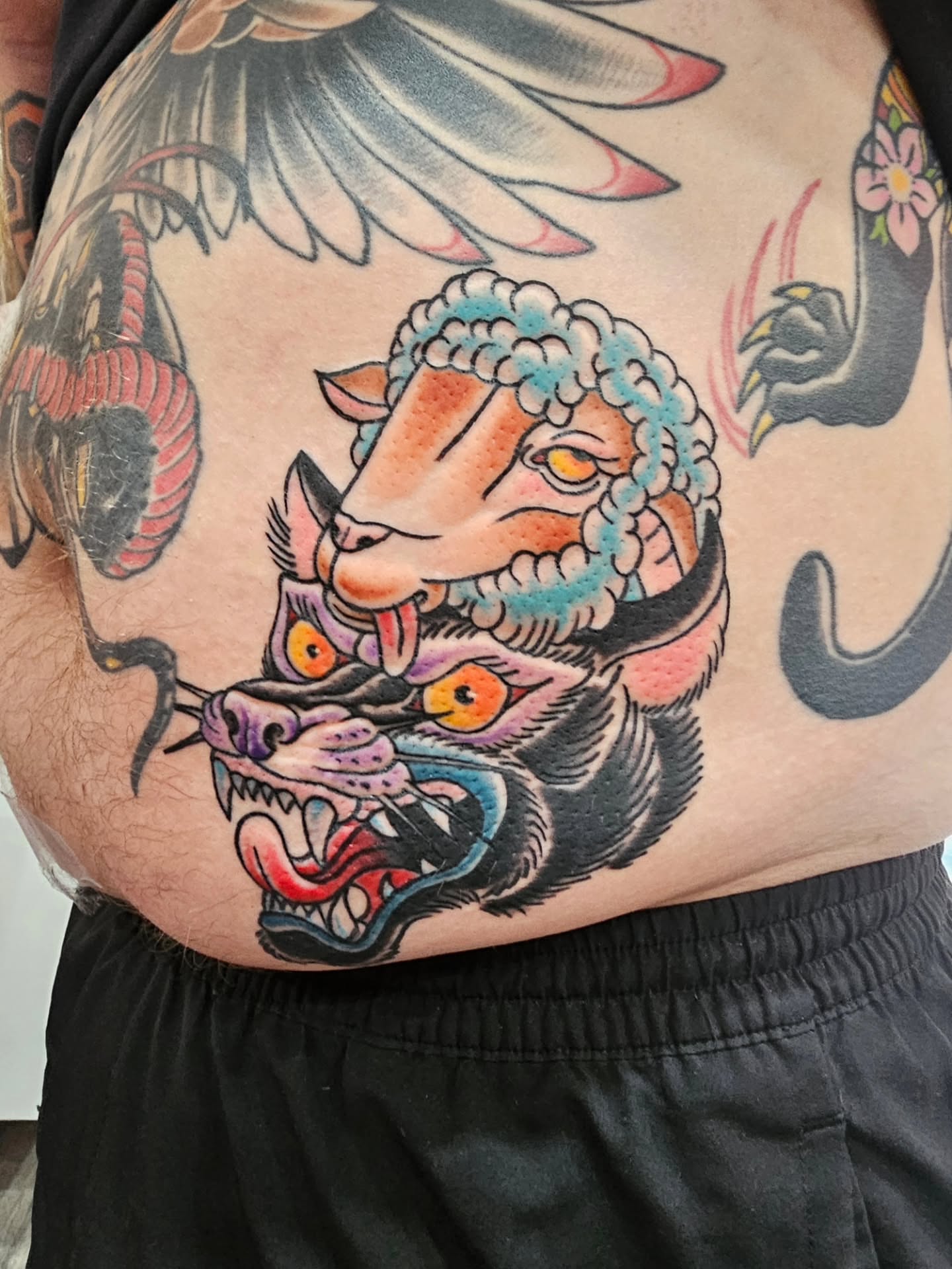 Sheep and wolf American traditional tattoo on the thigh by Matthew Ashmore