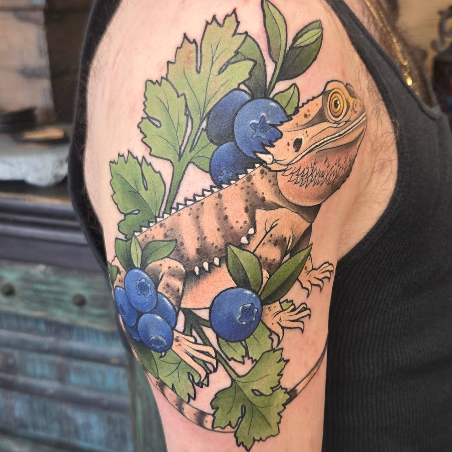 Gecko and blueberries realism tattoo on the upper arm by Brian Savage, Gilbert, Arizona