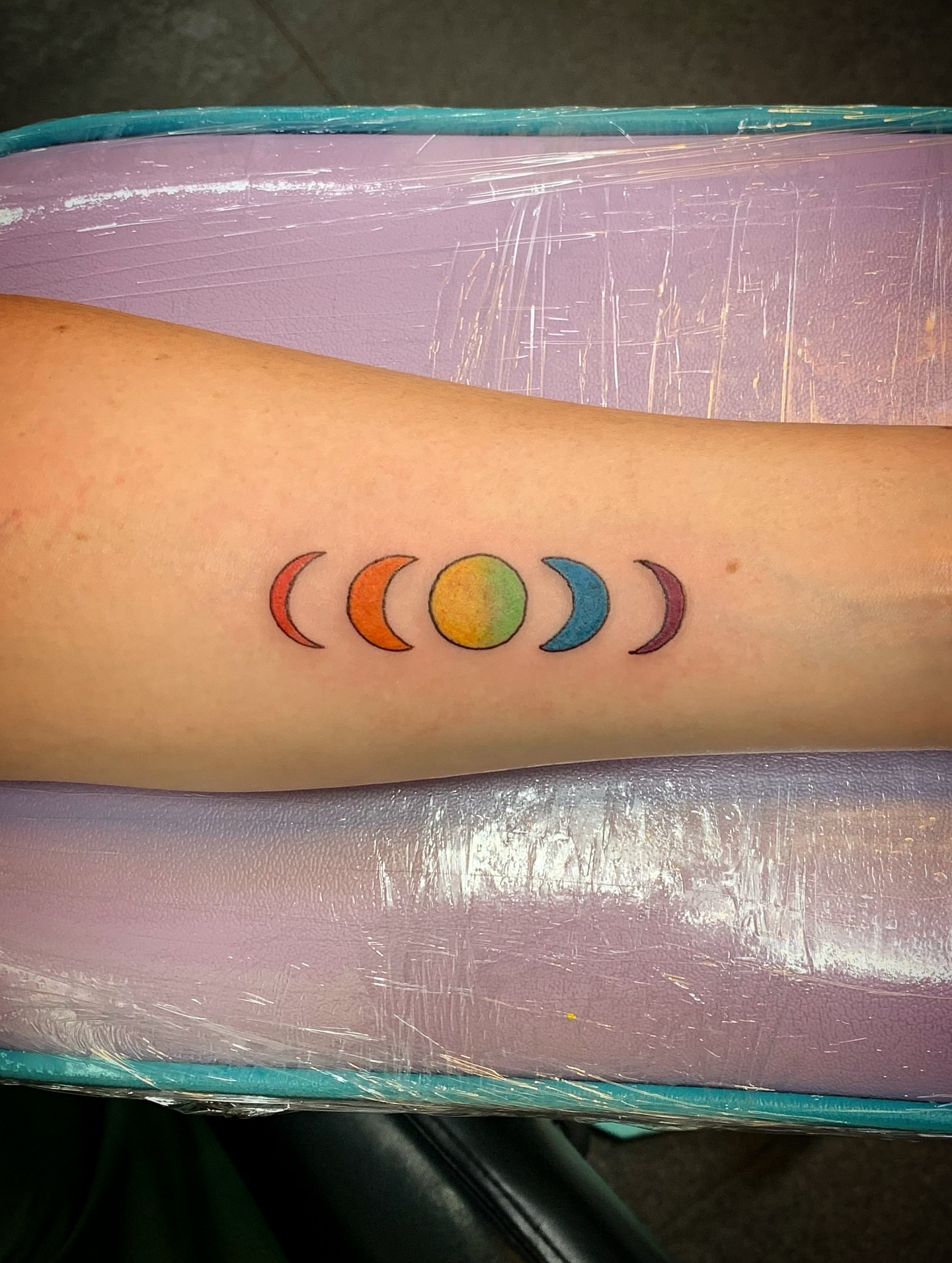 Moon phases dotwork tattoo on the forearm by Laura