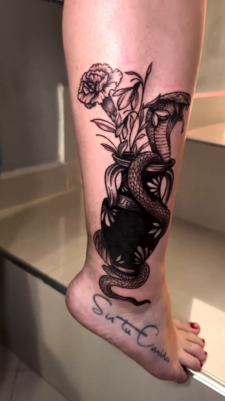 Snake and roses in a vase realism tattoo by Montreal Tattoo Artist