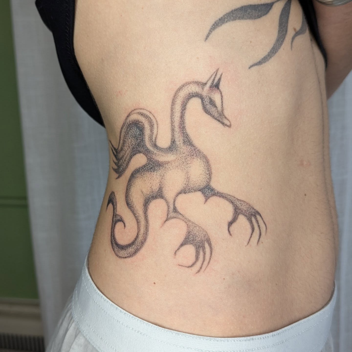 Phoenix dotwork tattoo on the ribs by theo, Portland, Oregon