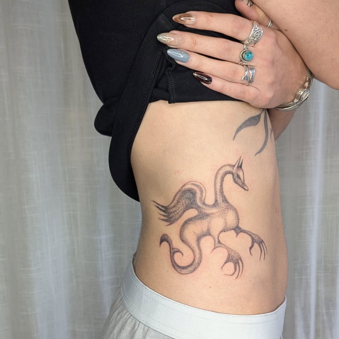 Phoenix dotwork tattoo on the ribs by theo, Portland, Oregon