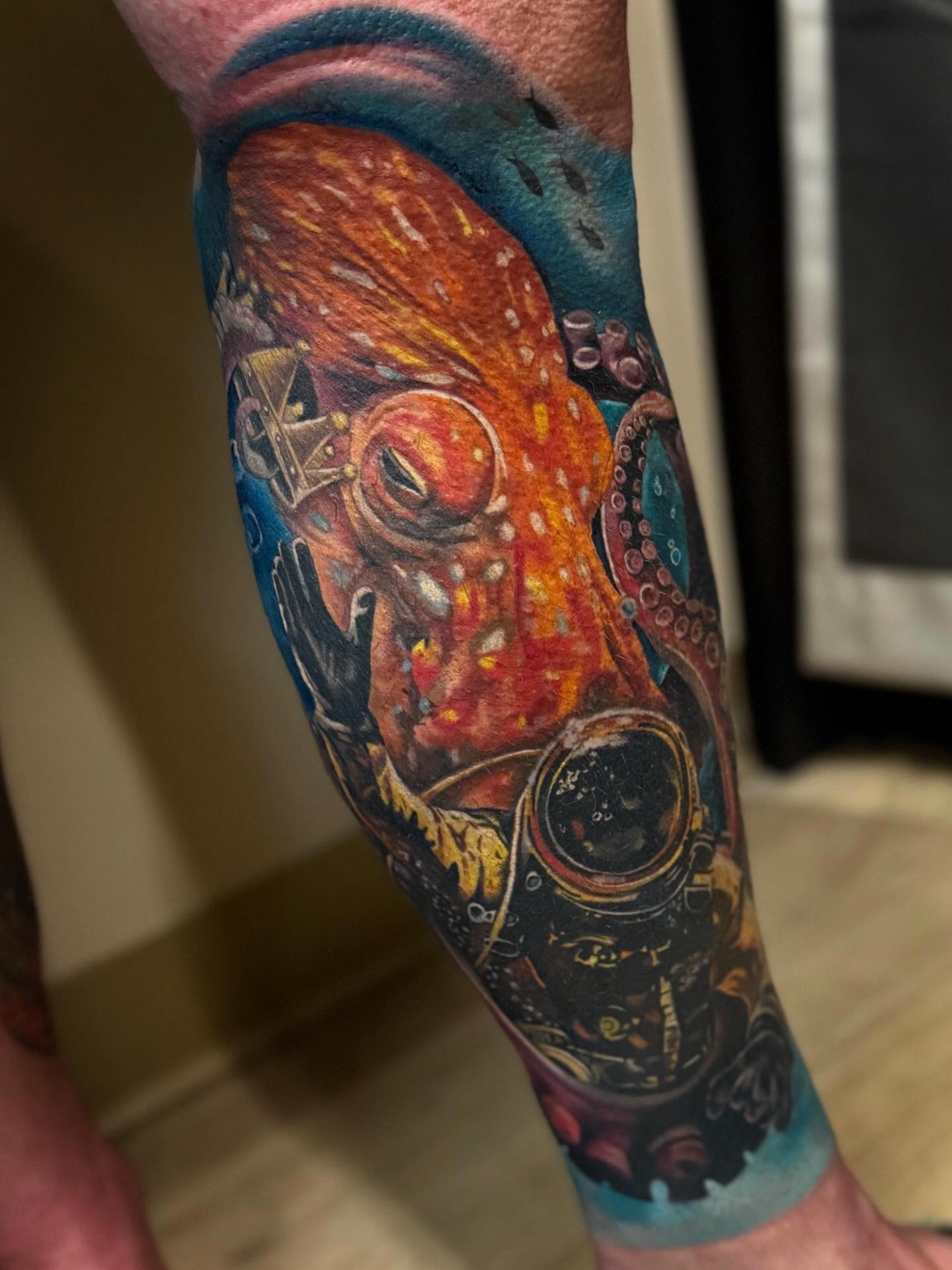Octopus and diver dotwork tattoo on the forearm by Su Kang