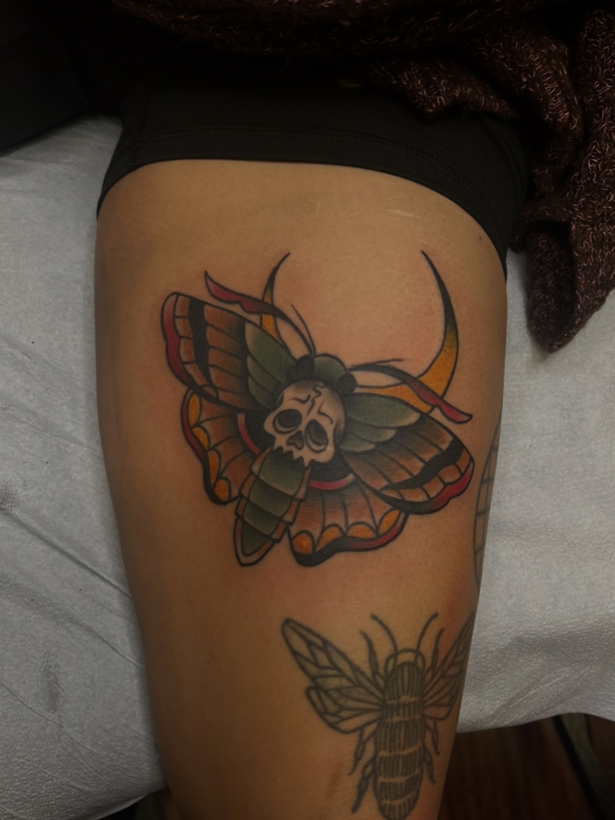 Moth with skull head American traditional tattoo on the thigh by Fizzy Jizzles, Worcester, England
