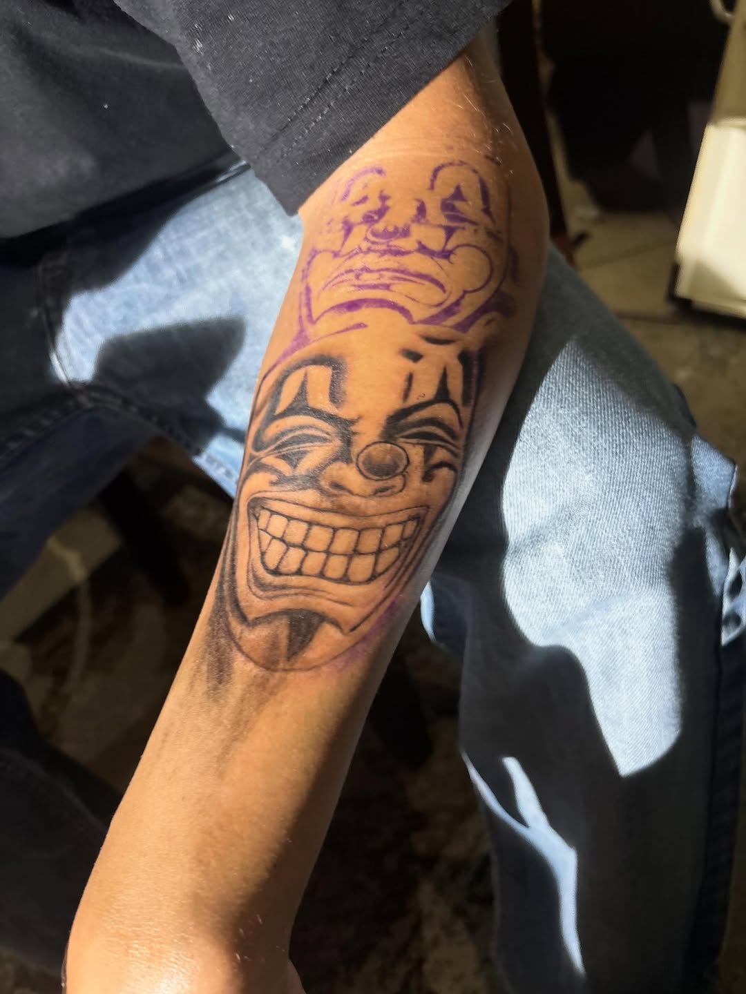 Clown faces realism tattoo on the forearm by Ink_ Hustle36