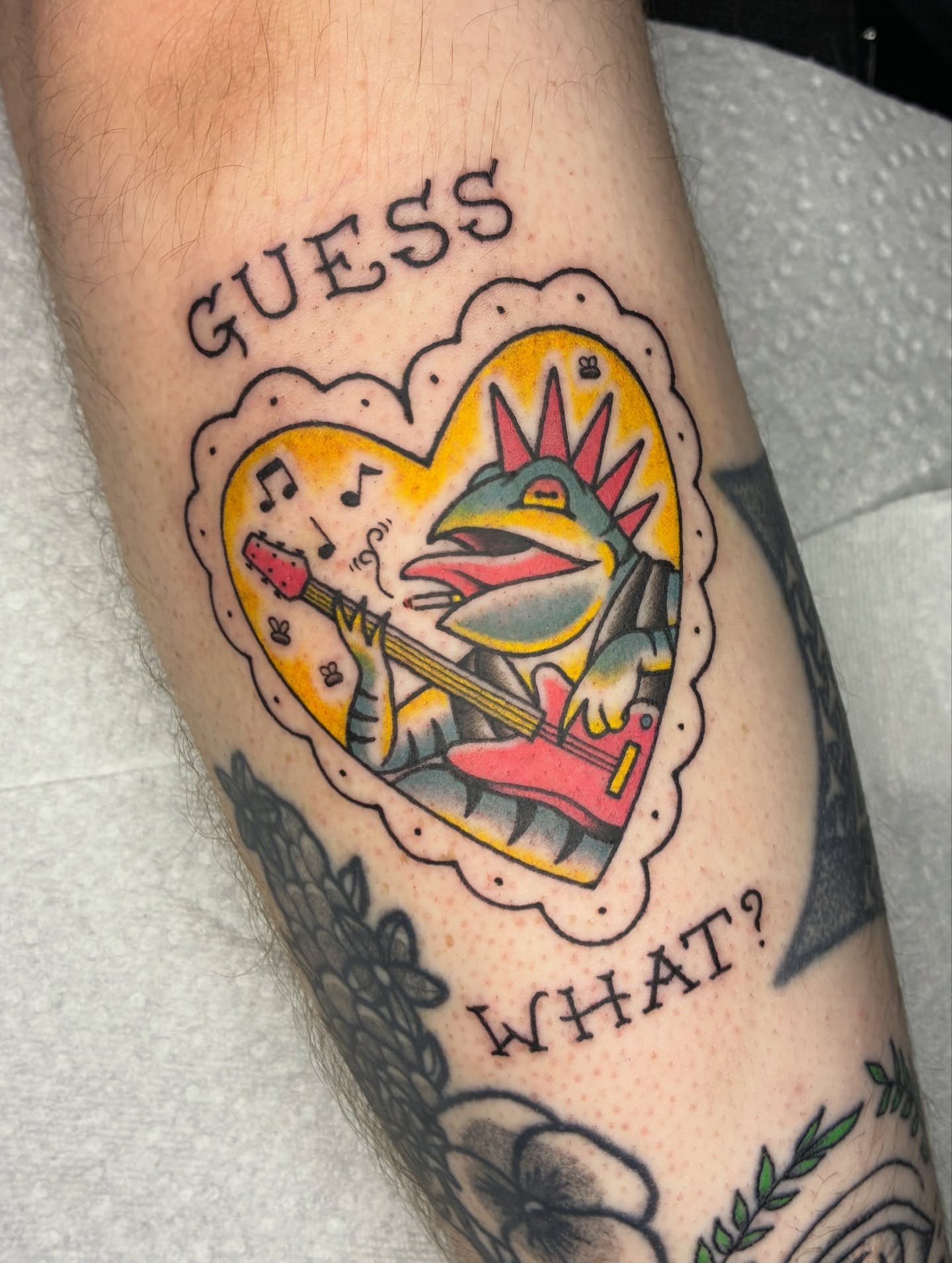 Bird playing guitar American traditional tattoo on the forearm by Lance 🦈