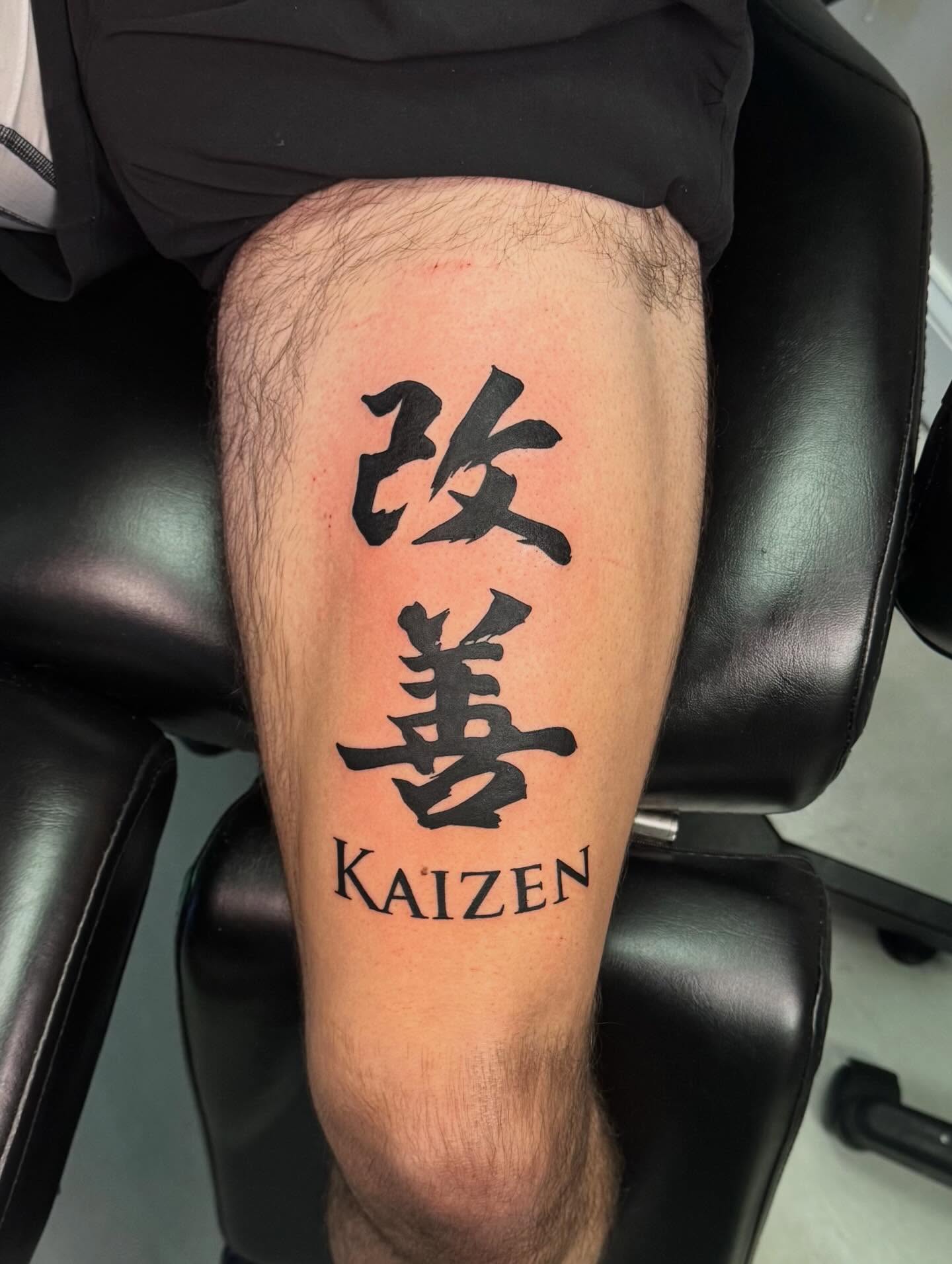 Kaizen black and grey tattoo on the leg by haylie