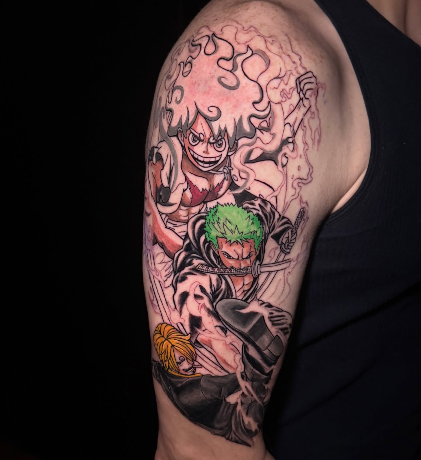 Anime characters anime tattoo on the upper arm by Cheyenne Ciera Goulish, Warren, Ohio