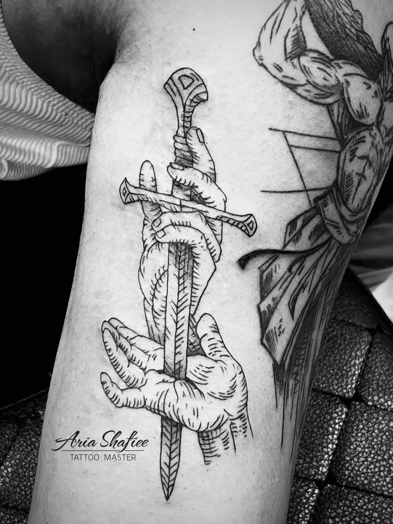 Sword and hands black and grey tattoo on the forearm by Aria Shafiee