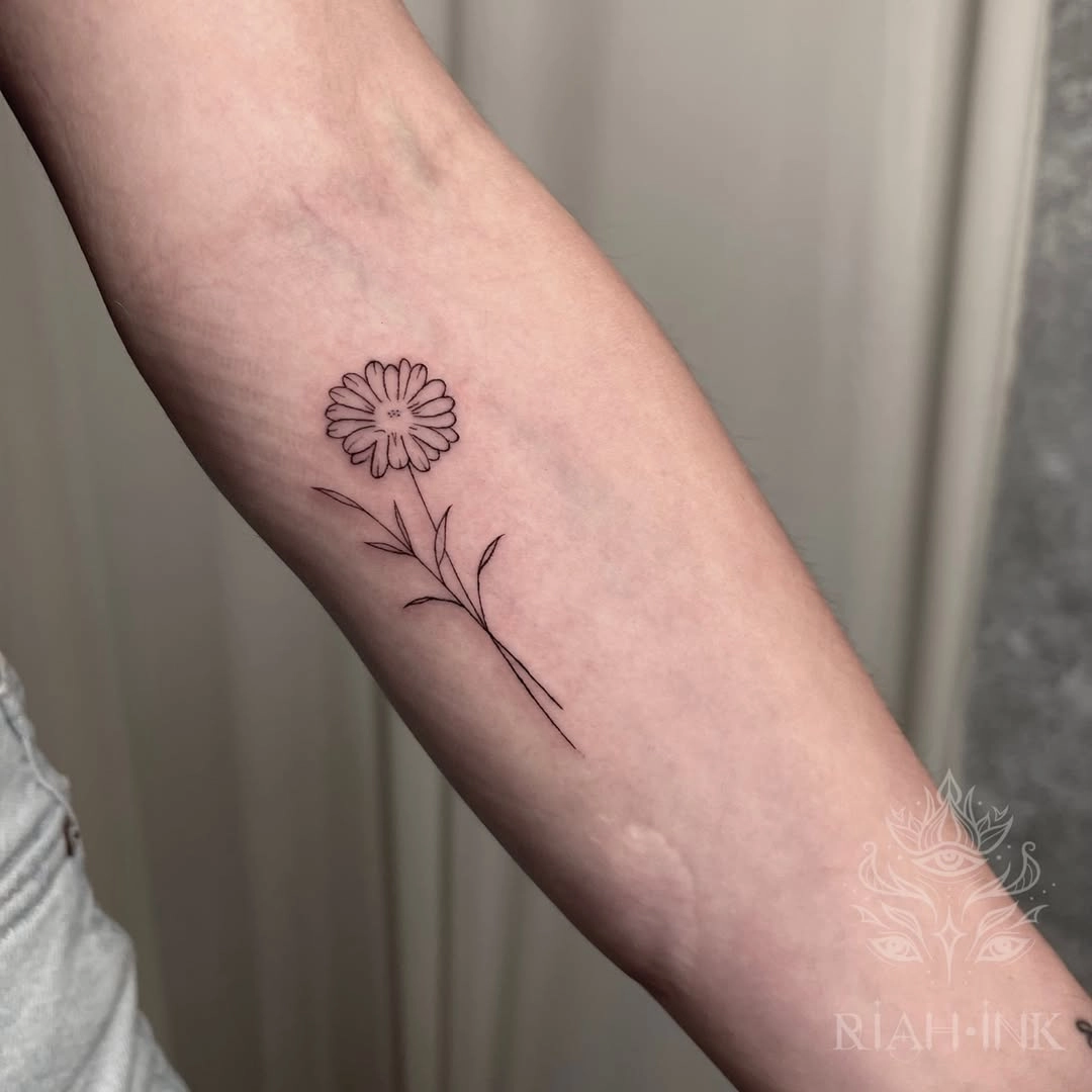 Flower fine line tattoo on the forearm by Donavon Batz