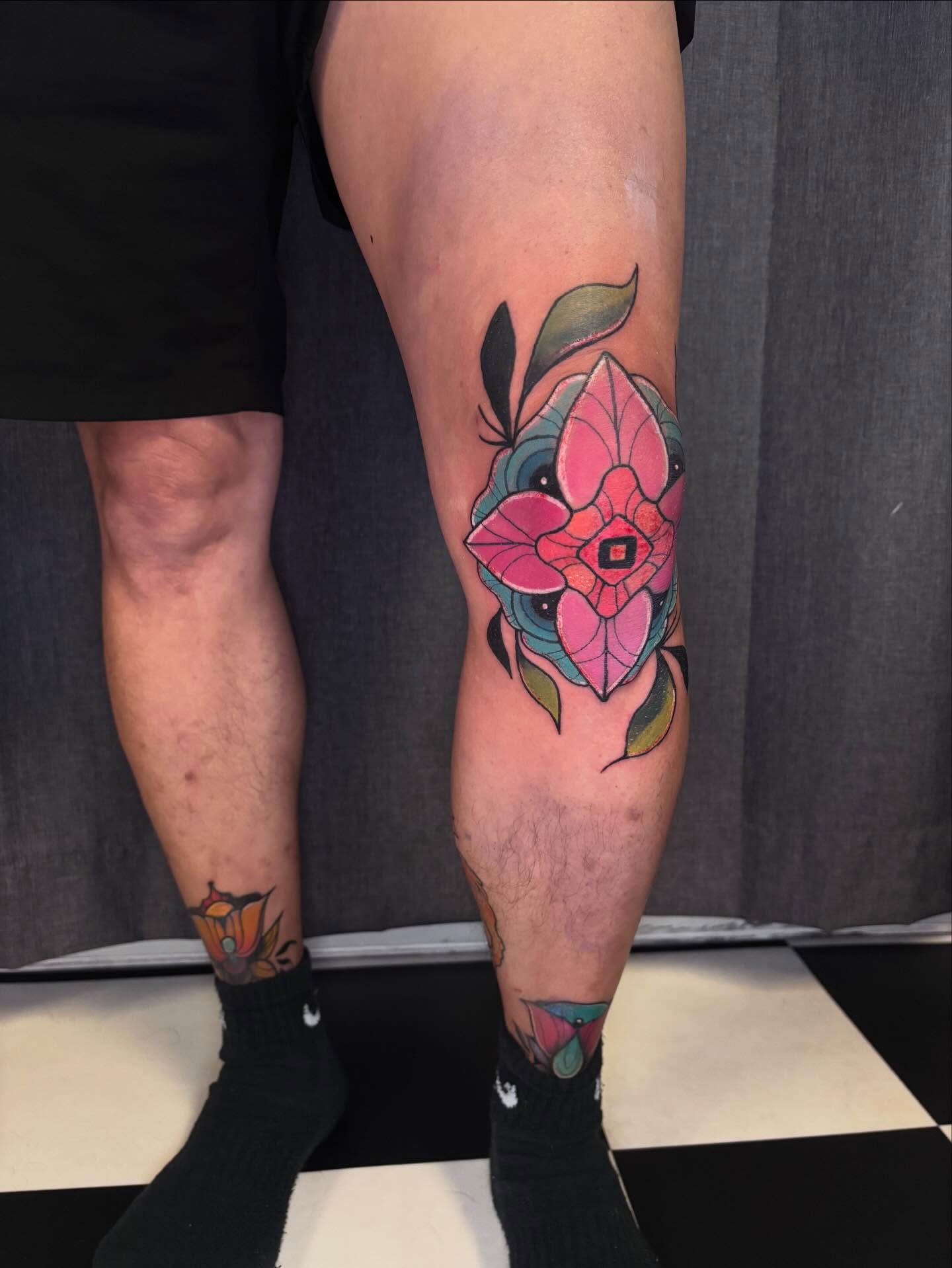 Flower new school tattoo on the calf by Riley Oats