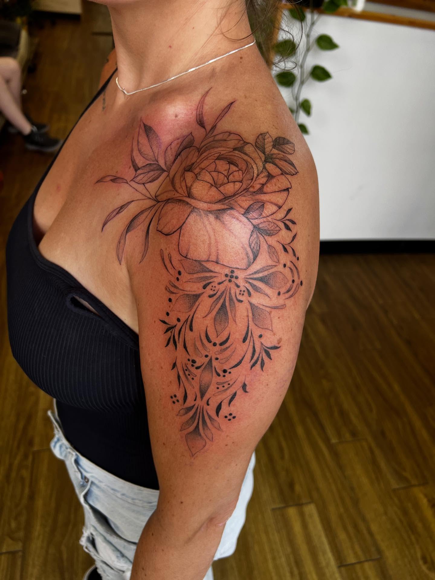 Floral arrangement black and grey tattoo on the shoulder by Rebecca Kern Tattoos