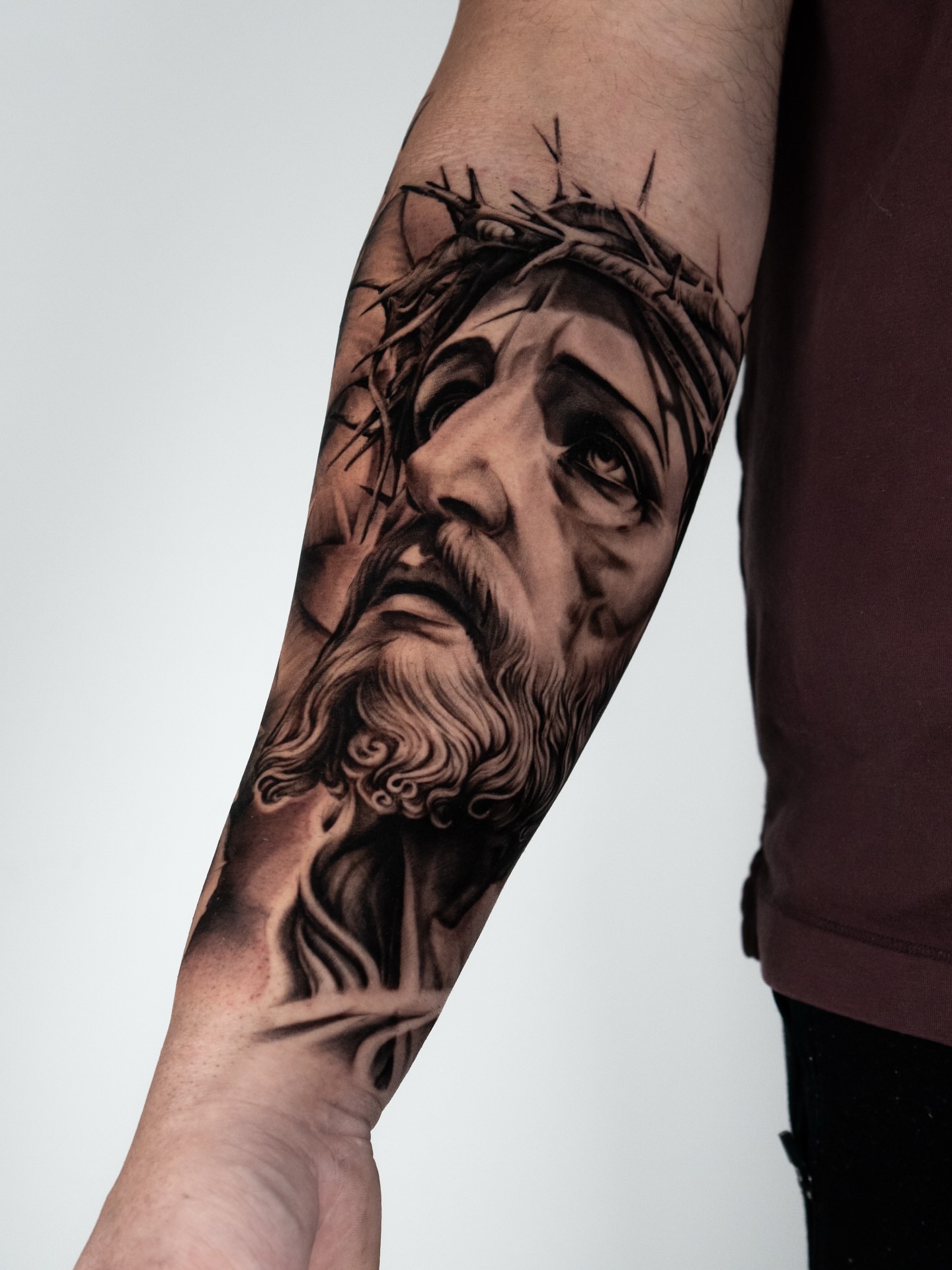 Religious figure realism tattoo on the forearm by Douglas Santos