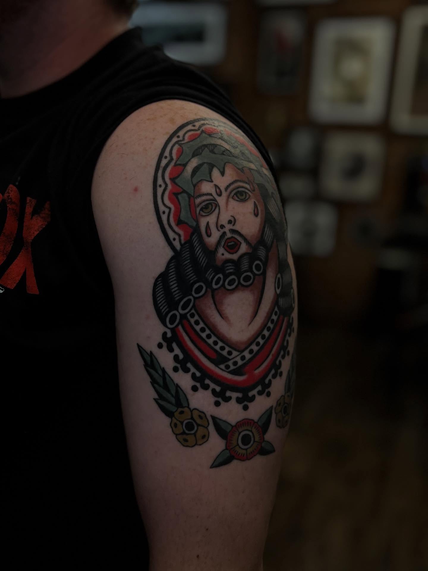 Jeweled figure American traditional tattoo on the shoulder by Syd Sayyah