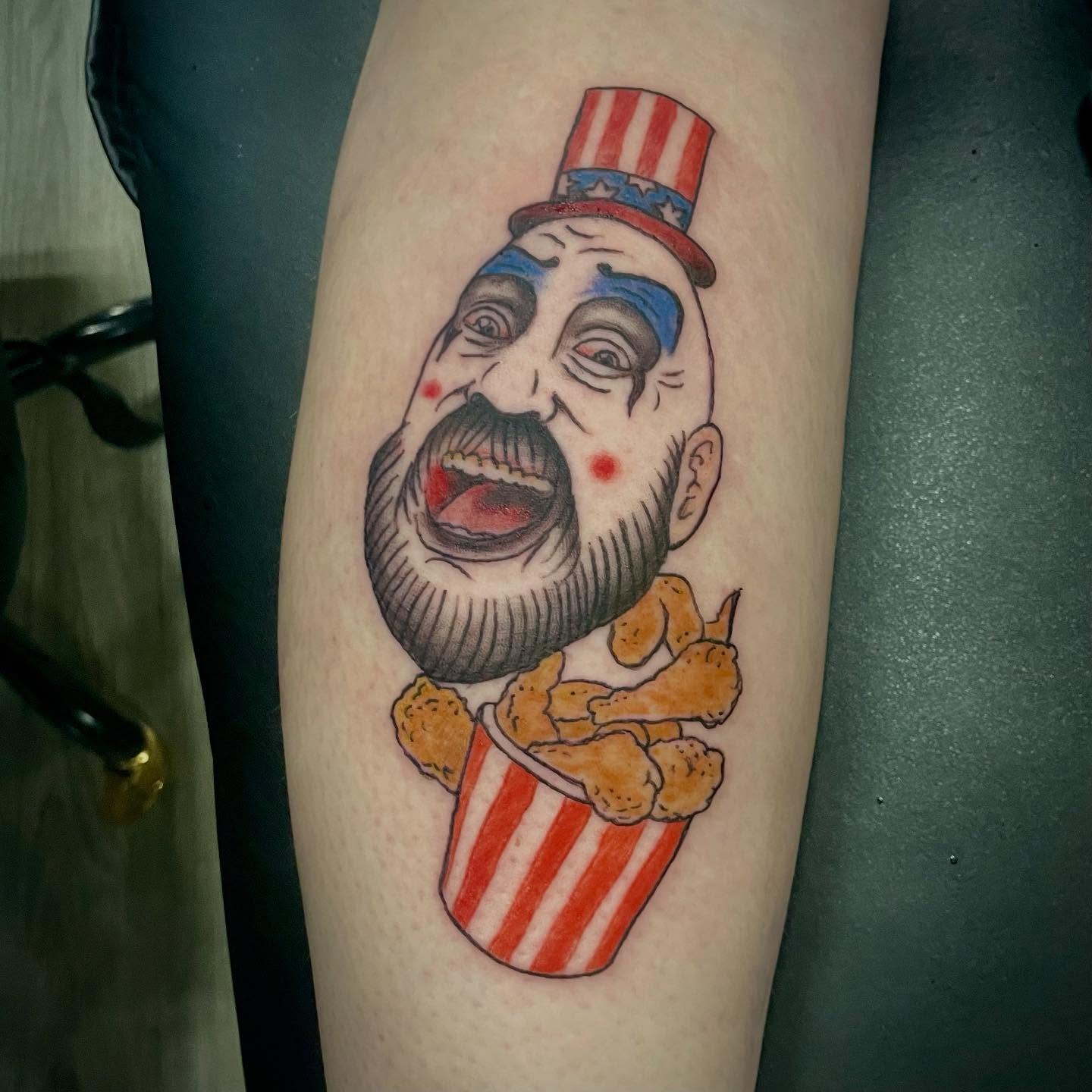 Clown with popcorn American traditional tattoo on the forearm by Logan Casimir