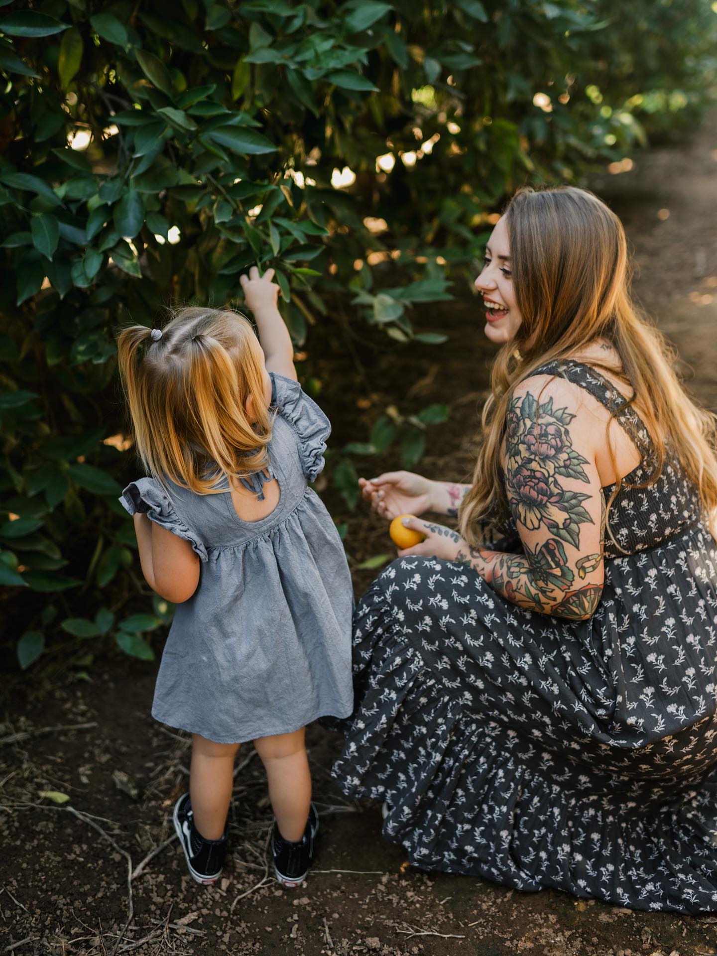 Floral black and grey tattoo on the upper arm by Chelstine, Encinitas, California