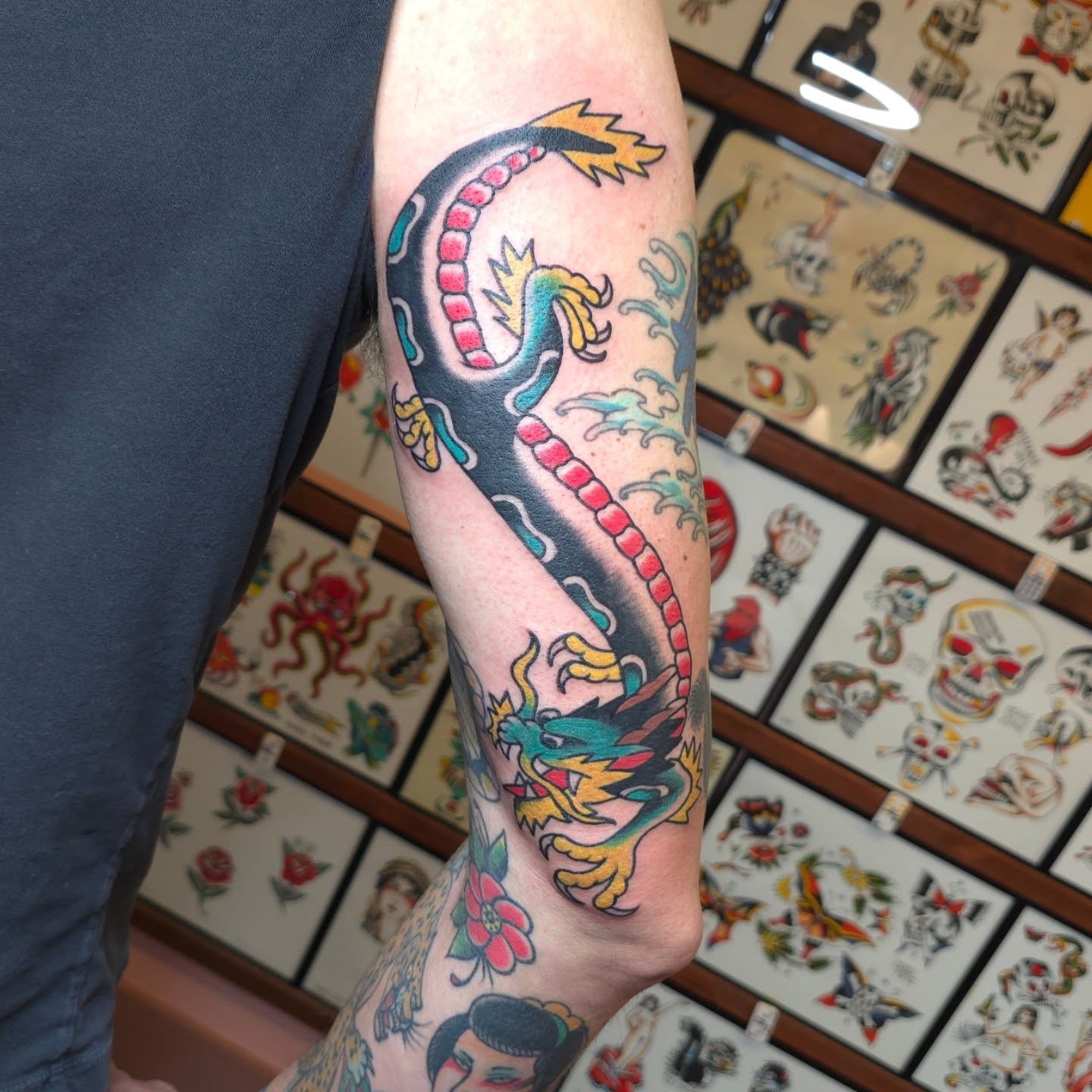Dragon American traditional tattoo on the forearm by Jared Green