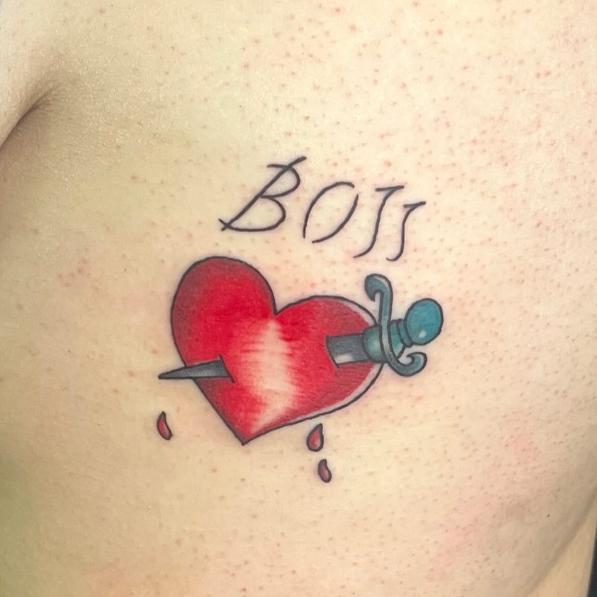 Heart with dagger American traditional tattoo on the chest by LooSid
