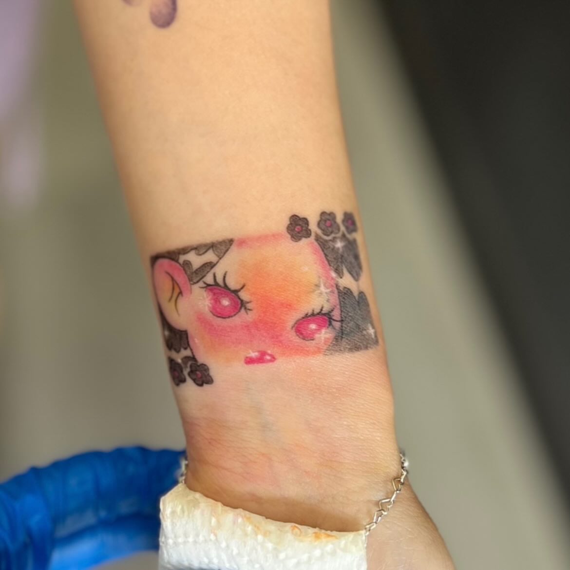 Kawaii character watercolor tattoo on the forearm by LooSid