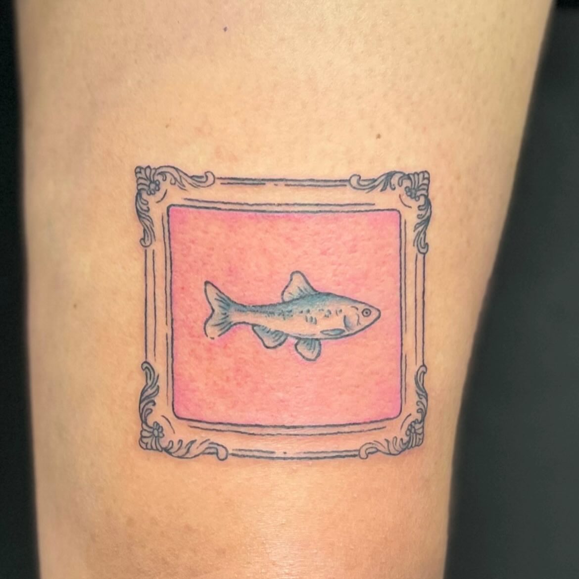 Fish in frame illustrative tattoo on the forearm by LooSid