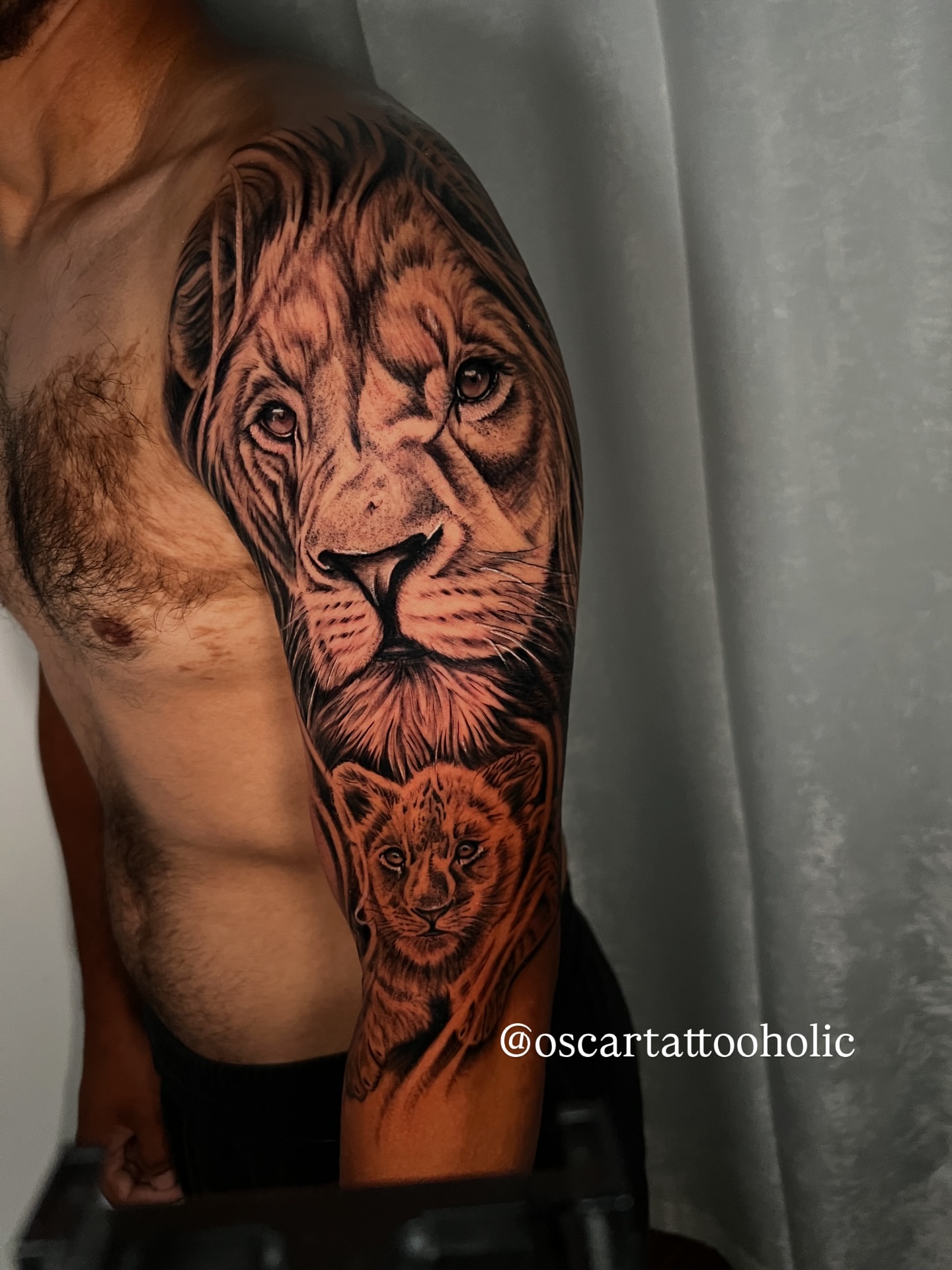Lion and cub realism tattoo on the upper arm by Oscar Tattooholic ( REALISM ANIME INK )