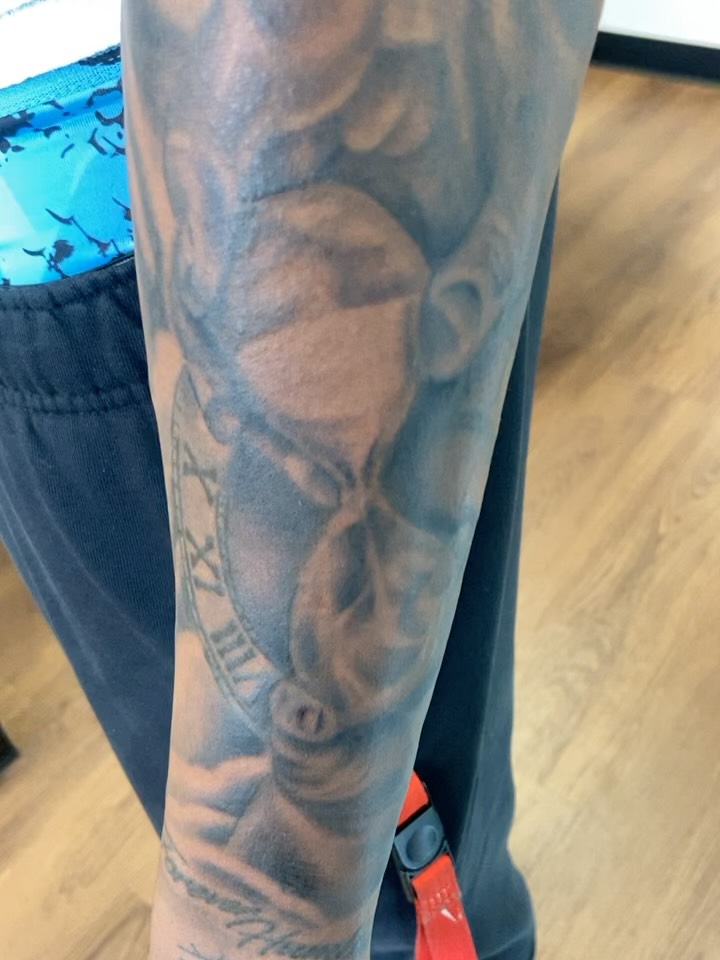 Hourglass black and grey tattoo on the forearm by Erin McGloin