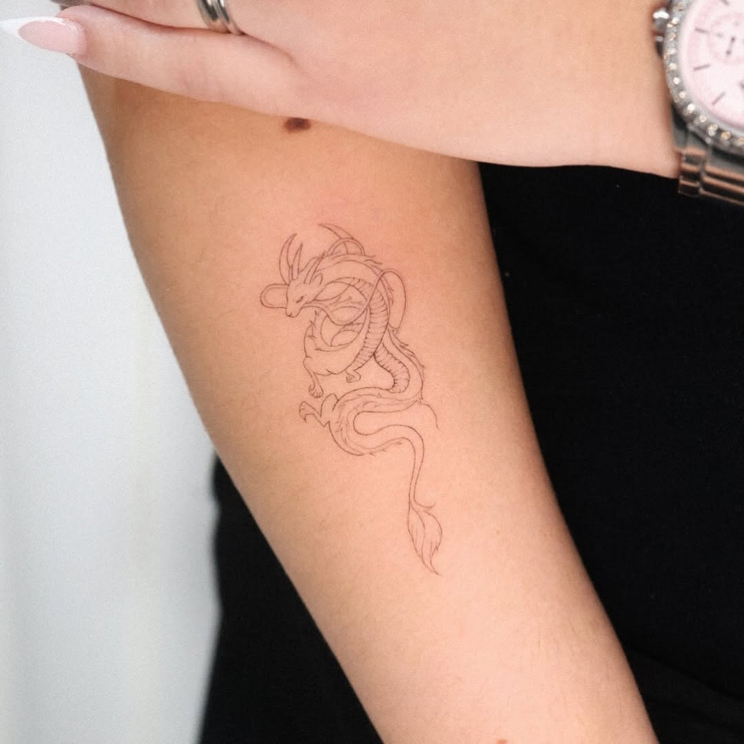 Dragon minimalist tattoo on the forearm by Fine Line, New York, New York