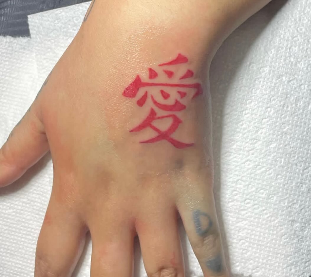 Kanji character lettering script tattoo on the hand by ART