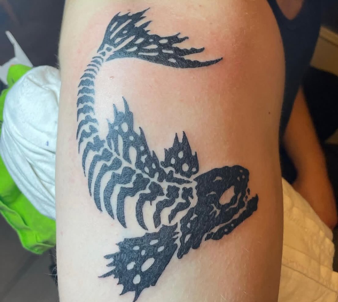 Fish geometric tattoo on the upper arm by ART