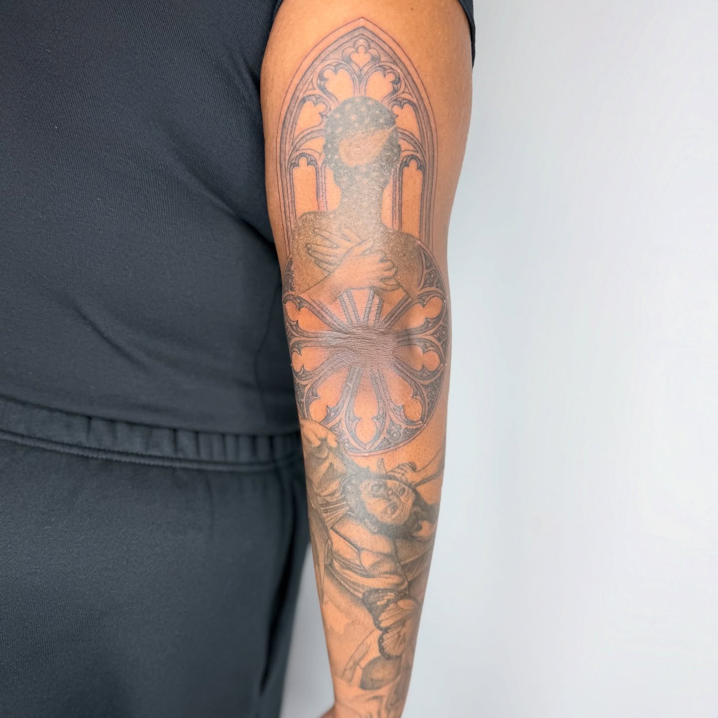 Religious figure black and grey tattoo on the forearm by Rose